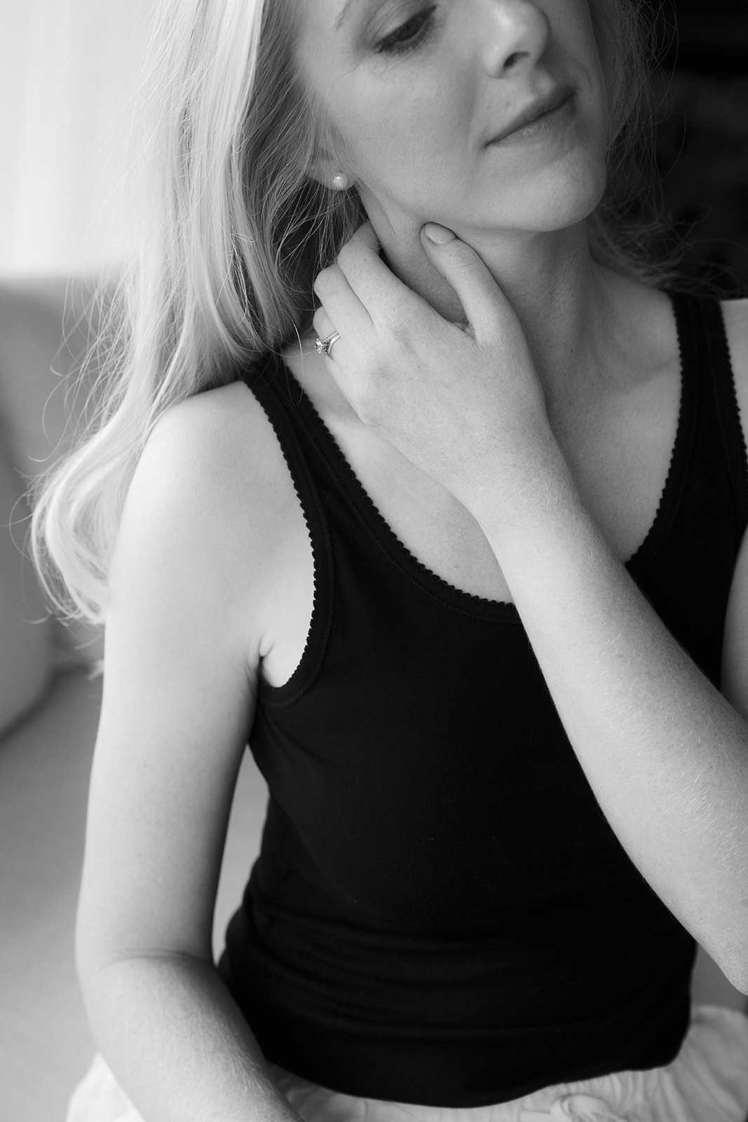 A woman gently massaging the side of her neck